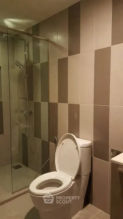 Modern bathroom with sleek tile design and glass shower enclosure