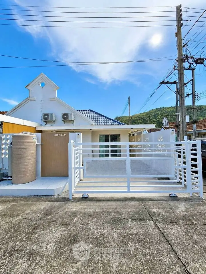 Charming single-story home with modern facade and gated entrance, perfect for cozy living in a serene neighborhood.