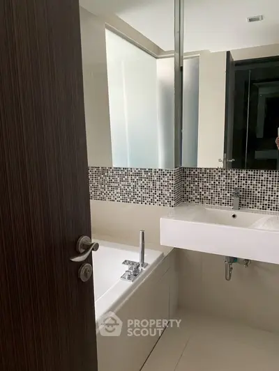 Modern bathroom with sleek design and mosaic tile accents