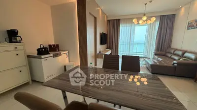 Modern living room with ocean view, stylish furniture, and elegant lighting