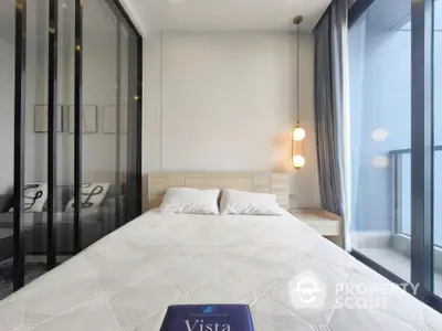 Modern bedroom with glass wall and balcony view in luxury apartment