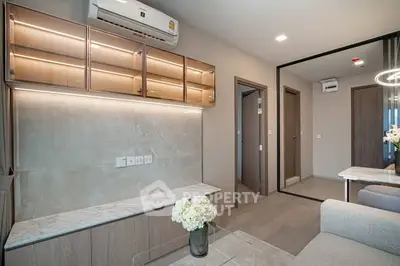 Modern living room with sleek design and built-in cabinets, featuring a cozy ambiance and elegant decor.