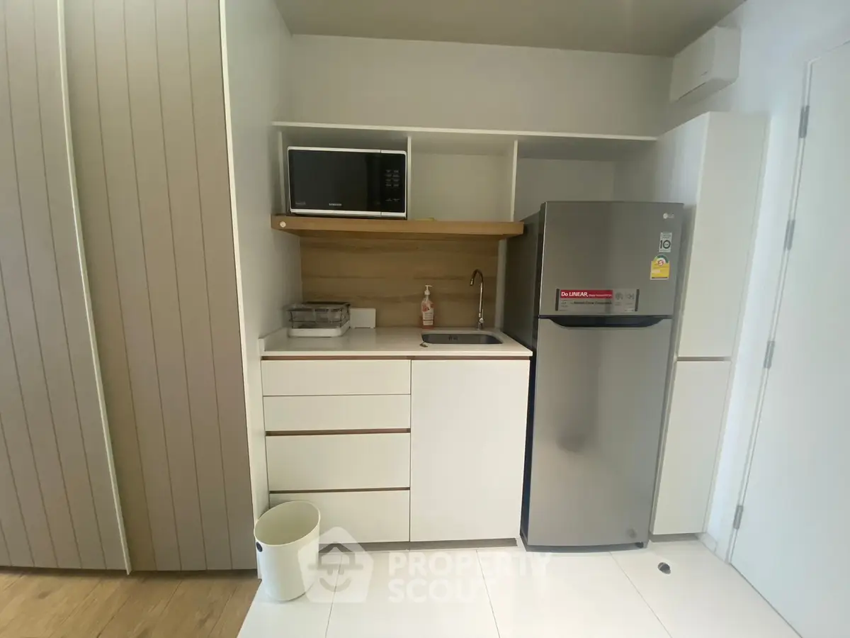 Modern compact kitchen with sleek appliances and minimalist design