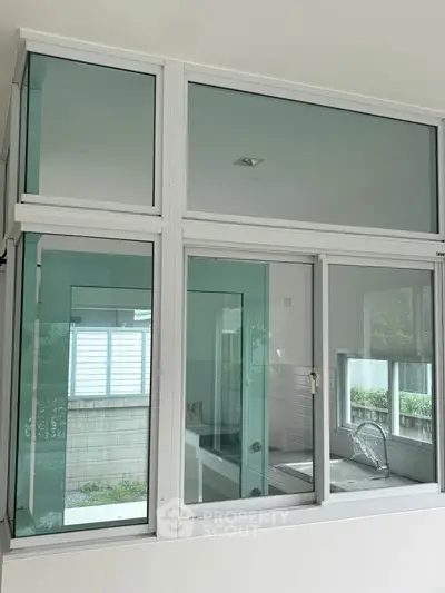 Modern bathroom with large glass windows and sleek fixtures