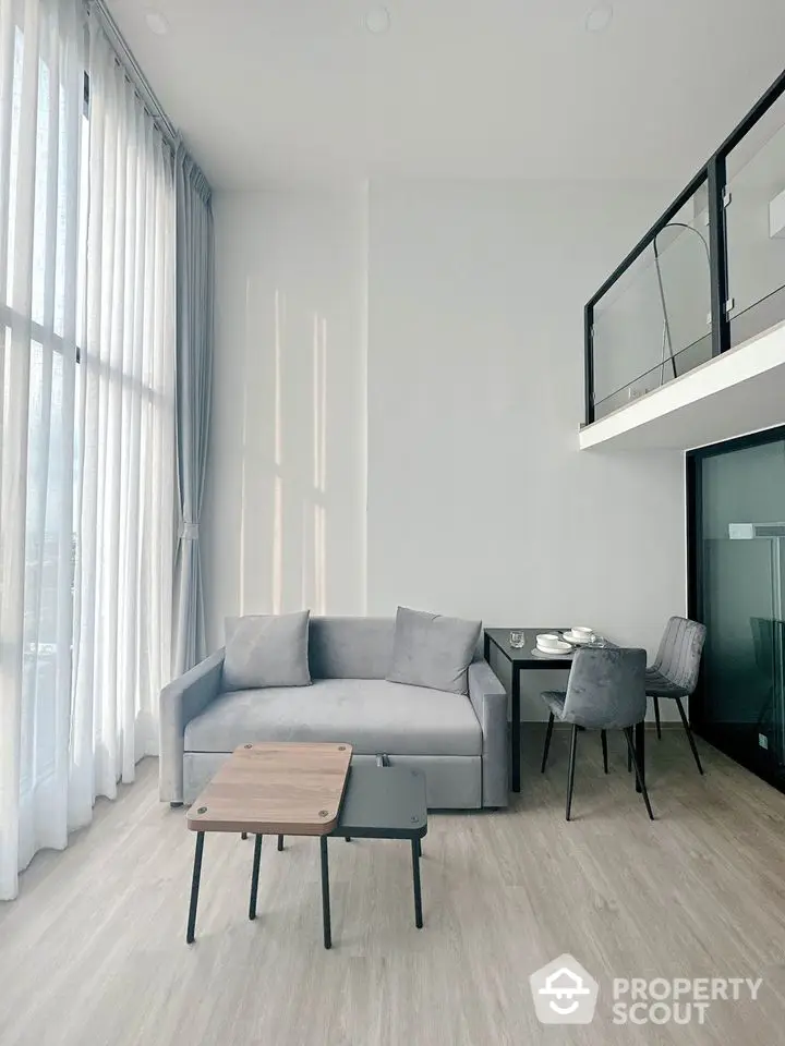 Modern loft living room with high ceiling and elegant decor