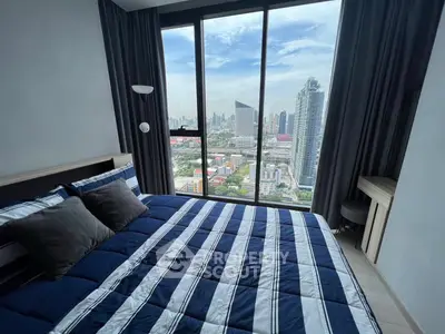 Luxurious bedroom with stunning city view from floor-to-ceiling windows