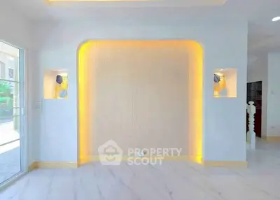 Modern interior with elegant lighting and marble flooring, showcasing a stylish feature wall.