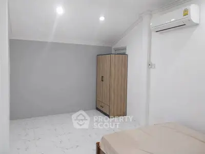 Minimalist bedroom with air conditioning and wardrobe