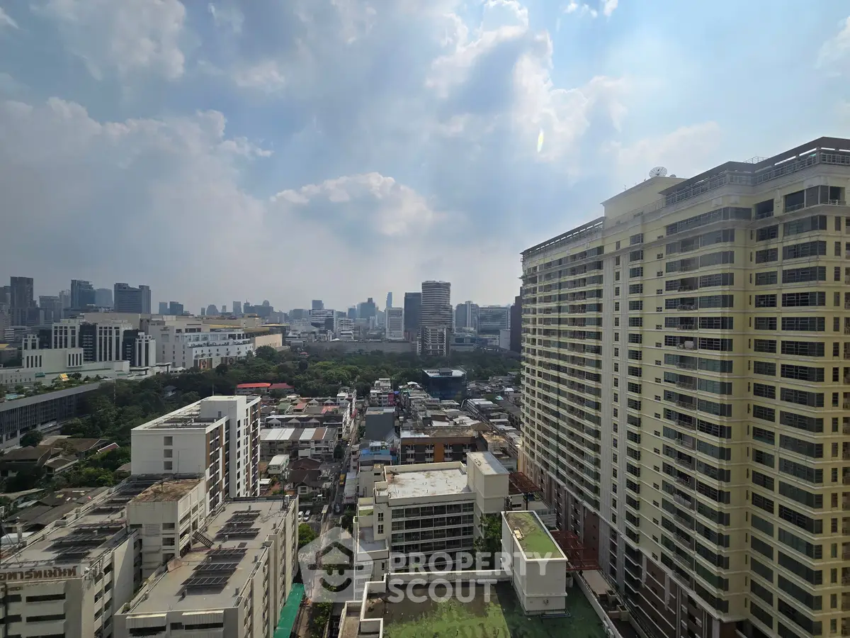 Stunning cityscape view from high-rise building showcasing urban skyline and architectural diversity.