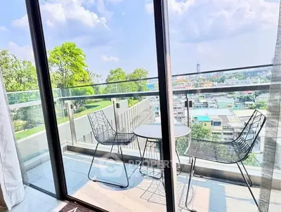 Chic balcony with modern furniture and stunning city view, perfect for relaxation and enjoying the outdoors.