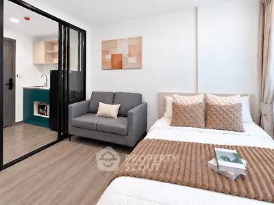 Modern studio apartment with cozy bed and stylish living area
