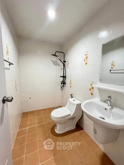 Modern bathroom with sleek fixtures and tiled flooring in a contemporary home.