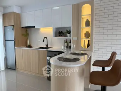 Modern kitchen with sleek cabinetry, built-in appliances, and stylish breakfast bar seating.