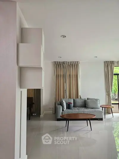 Spacious modern living room with elegant sofa and natural light