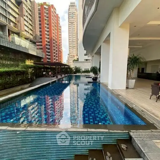 Luxurious high-rise apartment with stunning pool and city views.
