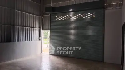 Spacious industrial-style storage unit with large roller door access.