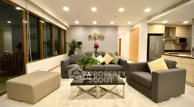 Luxurious modern living room with elegant decor and open kitchen layout, perfect for entertaining.