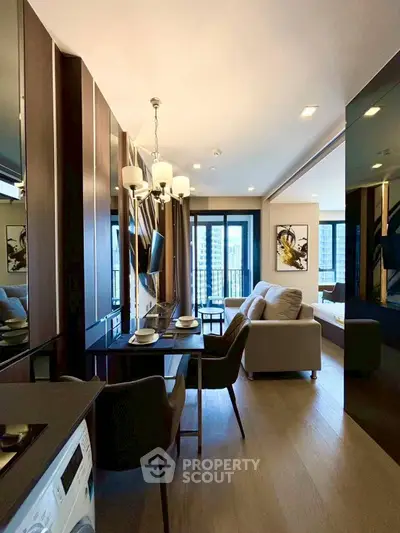 Modern open-plan living room with elegant decor and city view balcony.