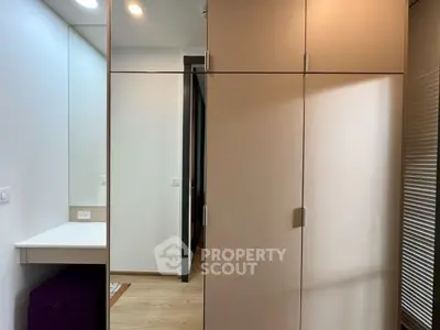 Modern bedroom with sleek wardrobe and vanity mirror