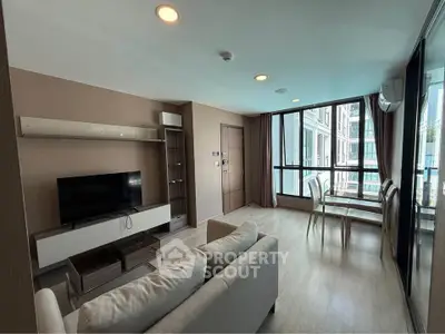 Modern living room with large windows and dining area in a stylish apartment