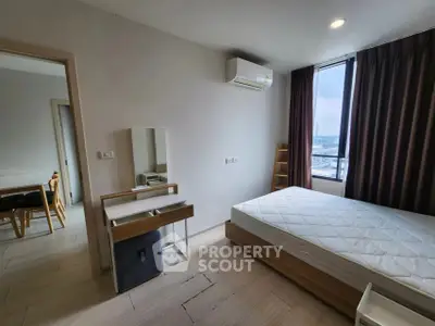 Modern bedroom with large window and minimalist furniture in urban apartment