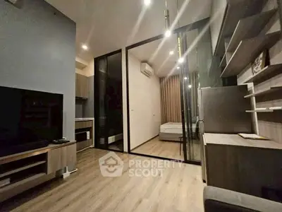 Modern apartment interior with glass-walled bedroom and sleek furnishings