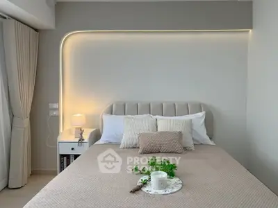 Elegant bedroom with modern lighting and cozy decor, perfect for relaxation and comfort.