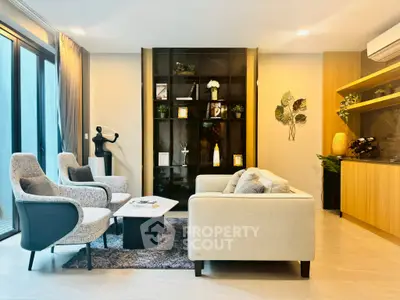 Modern living room with stylish furniture and large windows for natural light.
