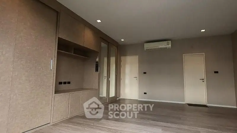 Spacious modern room with built-in storage and air conditioning