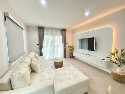 Modern living room with sleek white furniture and ambient lighting