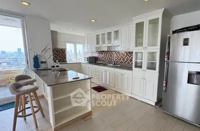Spacious kitchen with modern appliances and city view, featuring an open layout and stylish cabinetry.