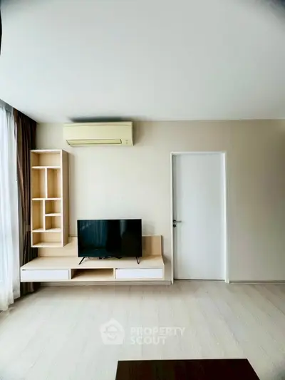 Modern living room with sleek TV setup and air conditioning