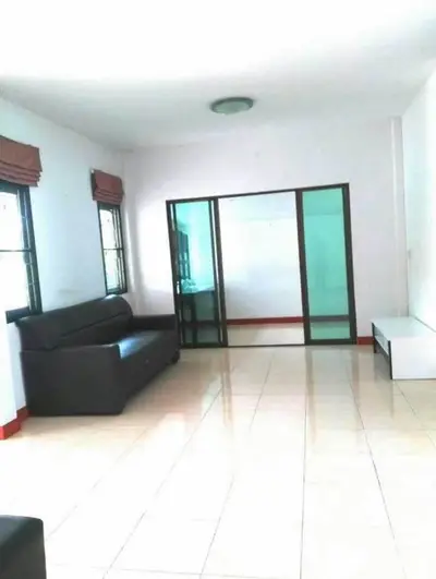 Spacious living room with tiled floor and modern furniture in a bright apartment.