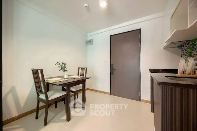 Modern dining area with elegant table and chairs in a cozy apartment setting.