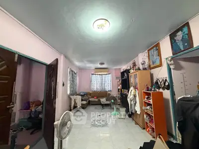 Spacious living room with cozy seating and ample natural light, perfect for relaxation and entertainment.