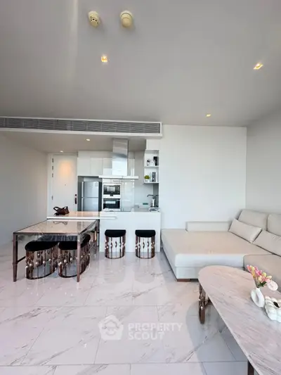 Modern open-layout living room with sleek kitchen and stylish furniture