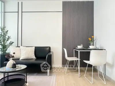 Modern living room with sleek black sofa and stylish dining area