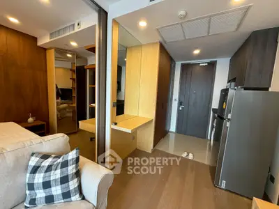 Modern apartment interior with cozy living area and sleek kitchen design.