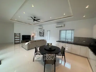 Spacious modern living room with open kitchen and sleek design