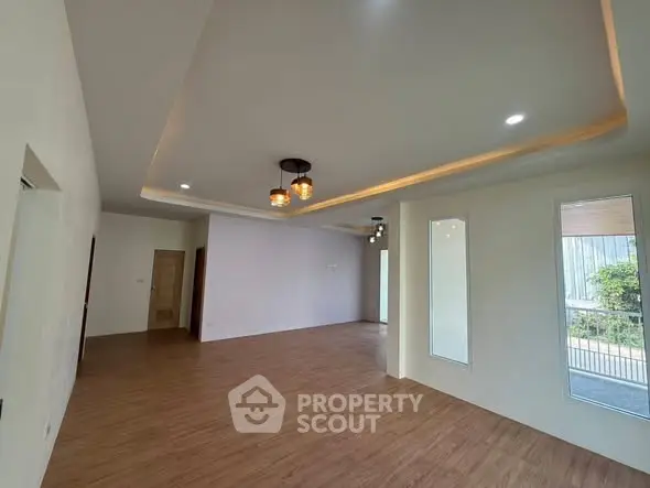 Spacious modern living room with elegant lighting and wooden flooring