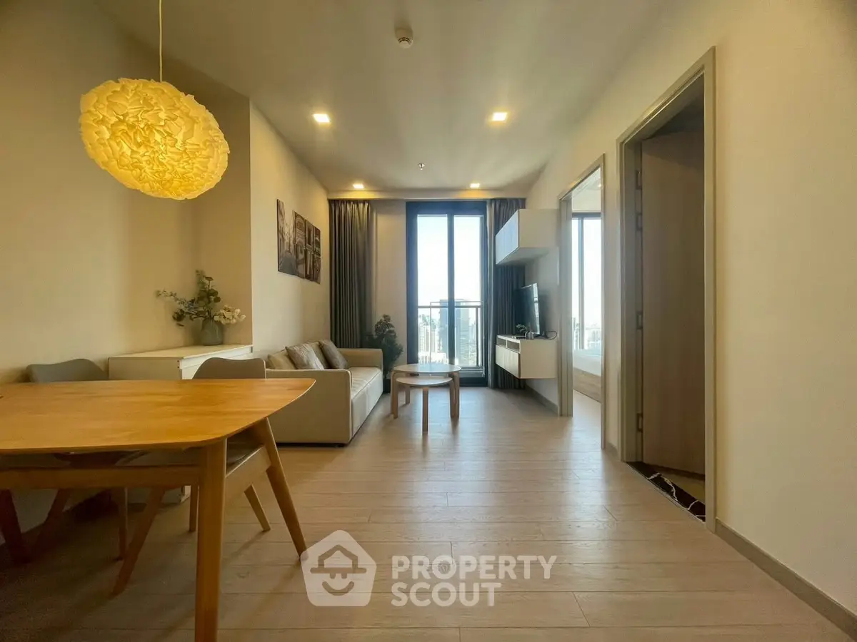 Modern living room with elegant decor and city view balcony