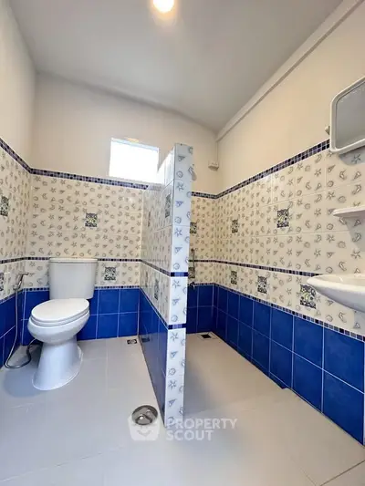 Charming bathroom with nautical-themed tiles and modern fixtures