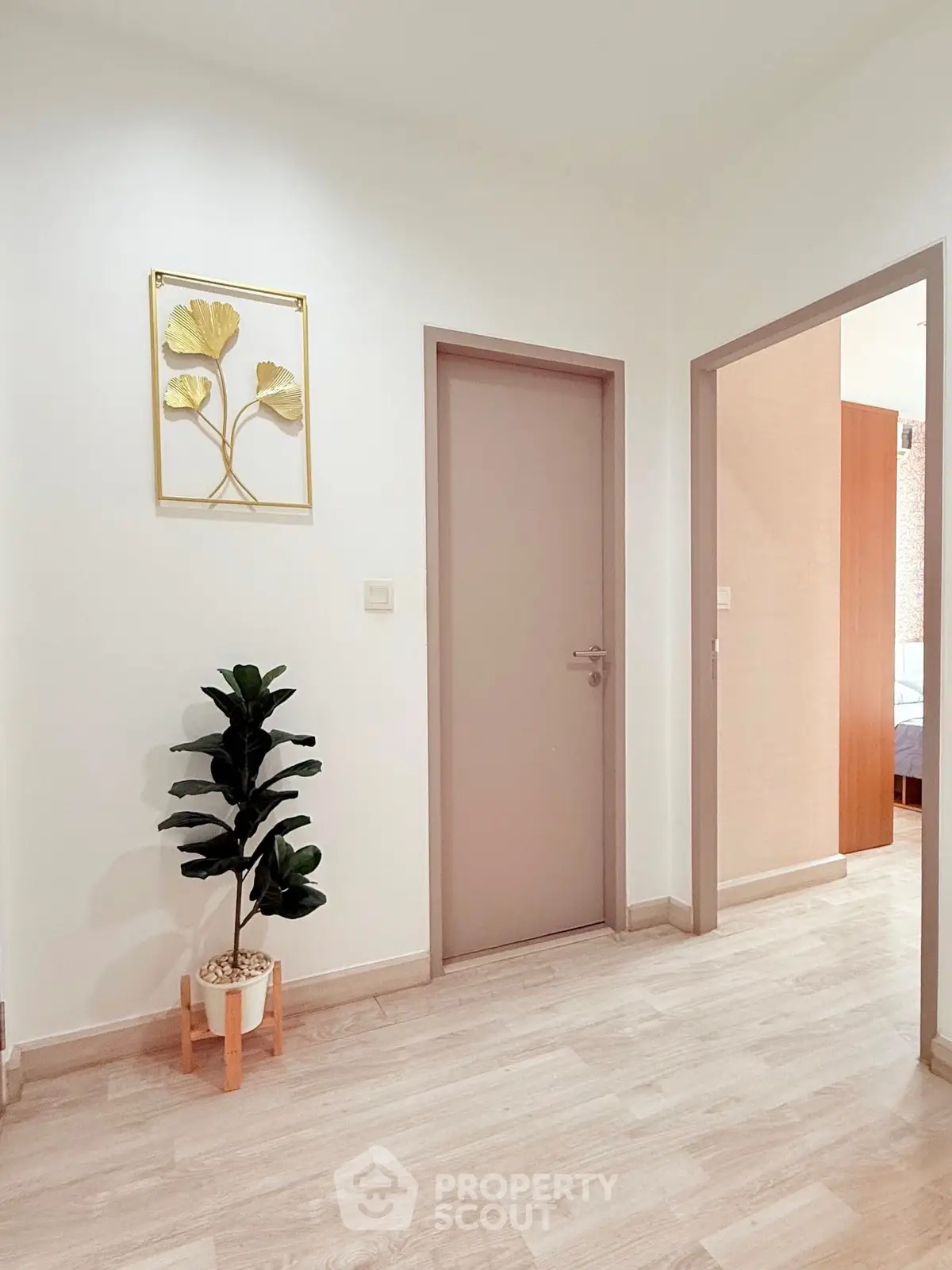 Modern minimalist interior hallway with plant and wall art