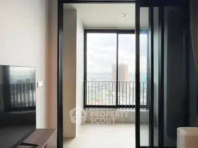 Modern apartment with stunning city view from balcony, featuring sleek sliding glass doors and elegant interior design.