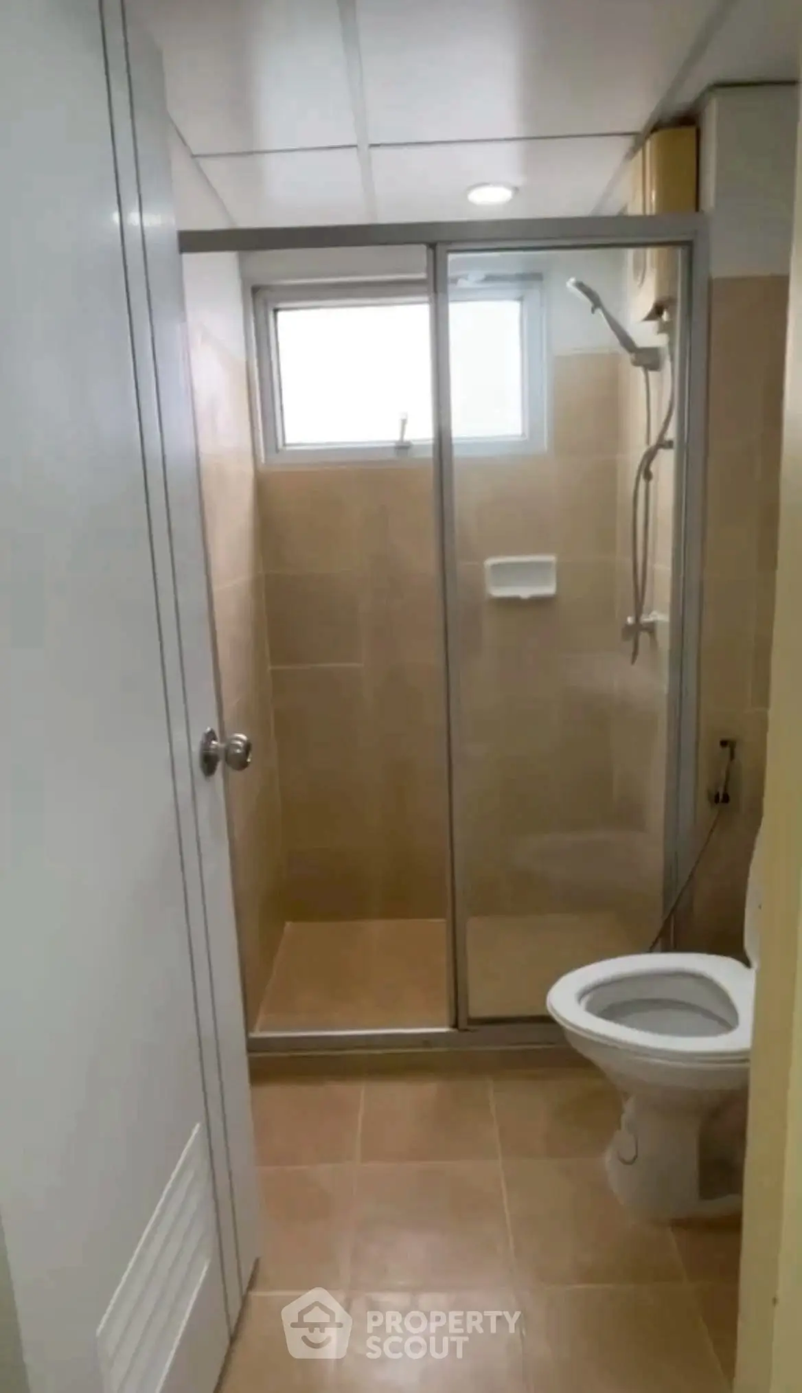 Compact bathroom with shower enclosure and modern fixtures, ideal for efficient space utilization.