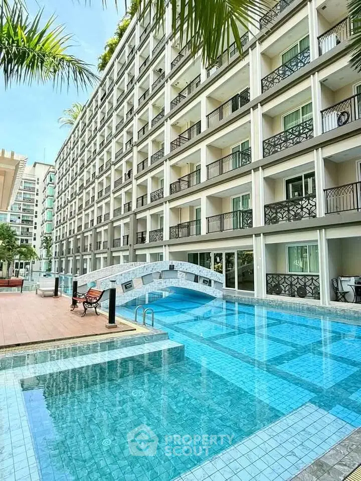 Luxurious apartment complex with stunning pool and modern architecture, perfect for upscale living.