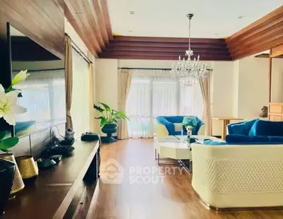 Luxurious living room with elegant chandelier and plush seating