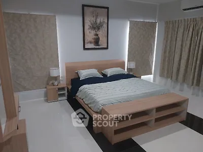 Spacious modern bedroom with elegant decor and natural light