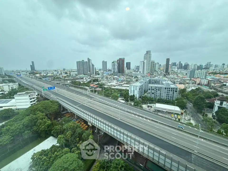 Stunning cityscape view from high-rise building overlooking urban skyline and highway.