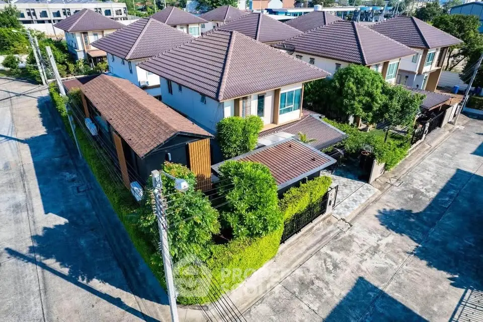 Charming corner unit house with lush greenery and modern design in a serene neighborhood.